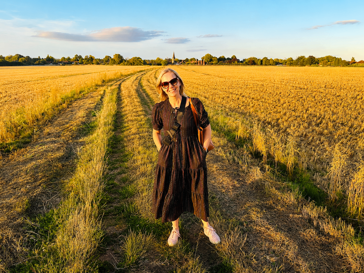 Holly standing in a golden Kent wheat field at sunset